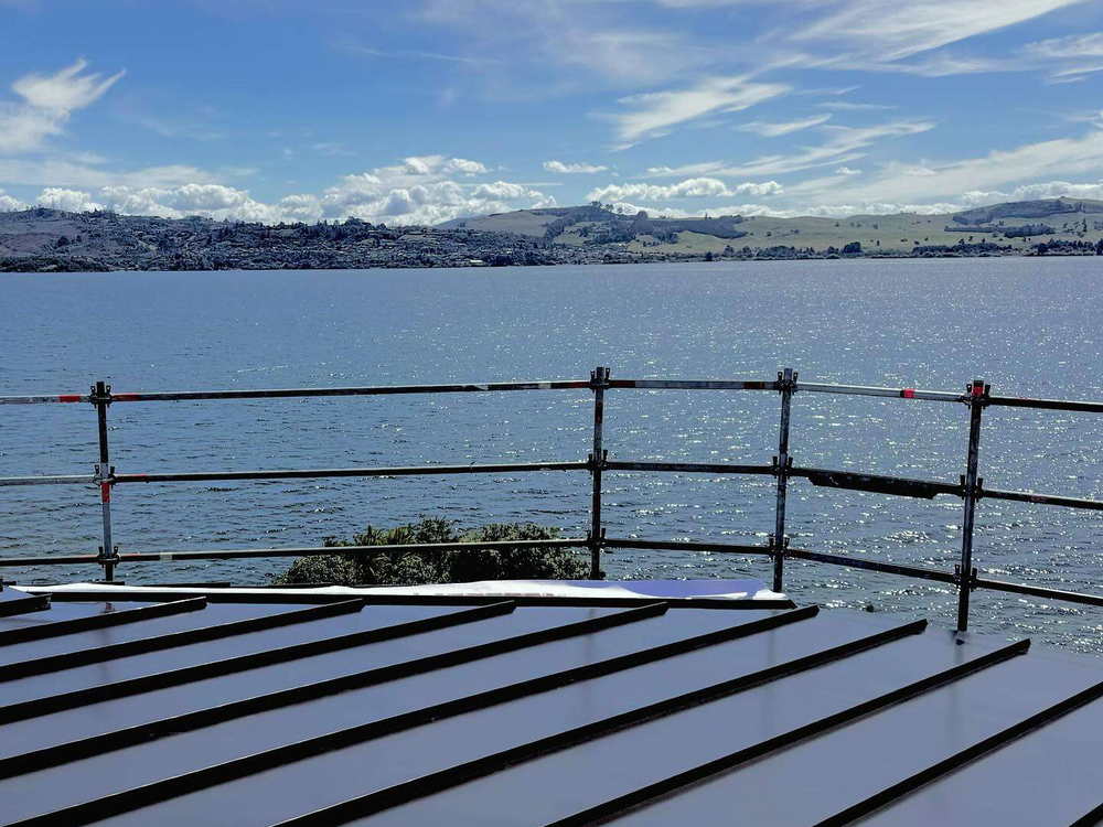 Dark tray roof with scaffolding up, looking out over the Tauranga harbour