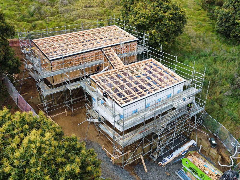 Aerial view of a two storey new build under construction with the roof framing in place